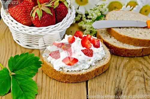 Image of Bread with curd cream and strawberries with a basket