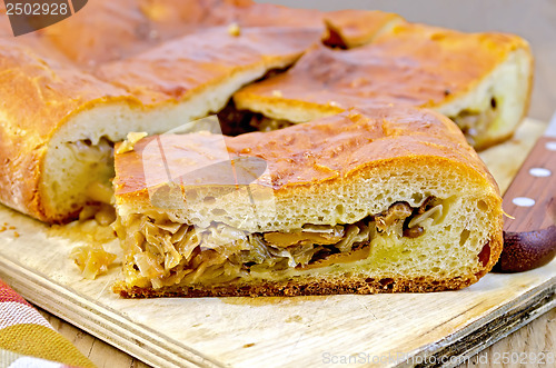 Image of Pie with cabbage and mushrooms on the board