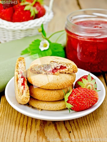 Image of Biscuits with strawberries and a basket on the board