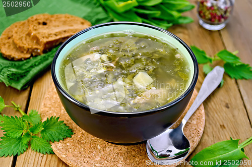 Image of Soup green of sorrel and nettles with bread on the board