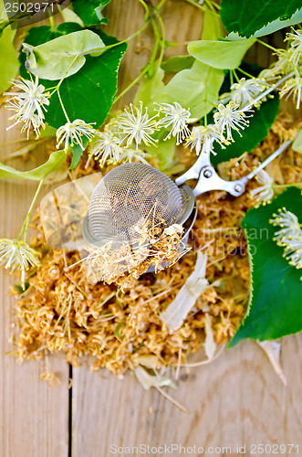 Image of Herbal tea from linden flowers in a tea strainer