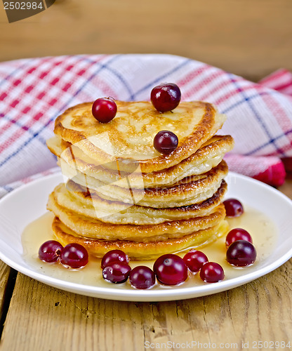 Image of Flapjacks with cranberries and honey on the board