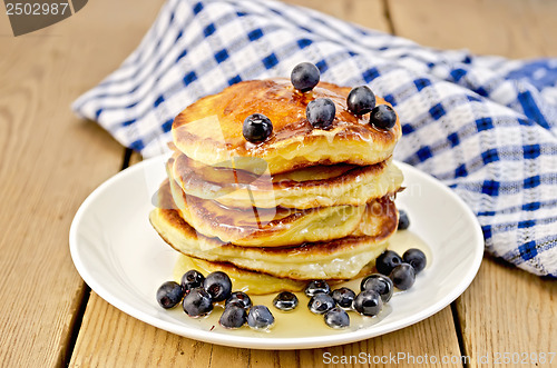 Image of Flapjacks with blueberries and a napkin on the board