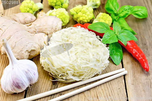 Image of Noodles rice with spices and broccoli on the board