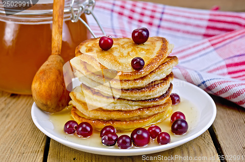 Image of Flapjacks with cranberry and spoon on board