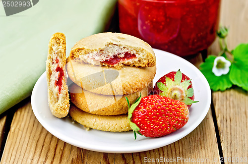 Image of Biscuits with strawberries and jam on the board