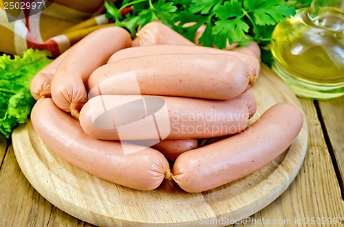 Image of Sausages on a board with parsley