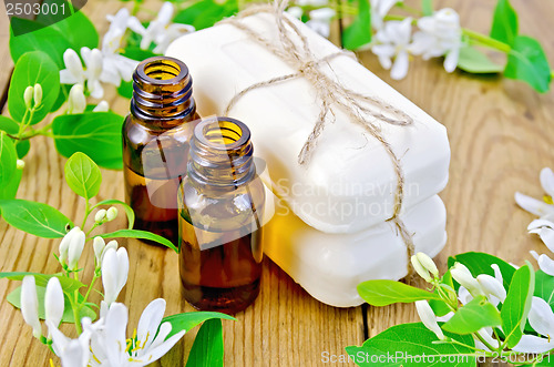 Image of Oil and white soap with flowers of honeysuckle