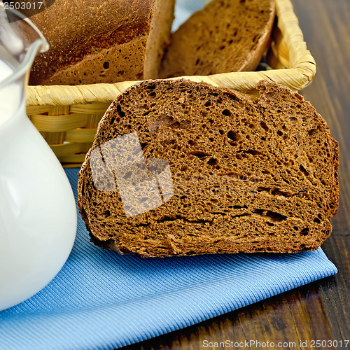 Image of Rye homemade bread with milk on the board