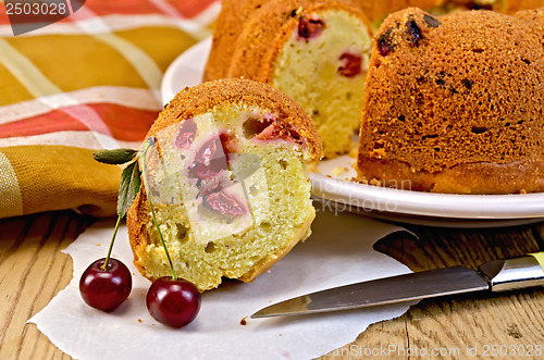 Image of Cake with berries cherries and napkin on the board