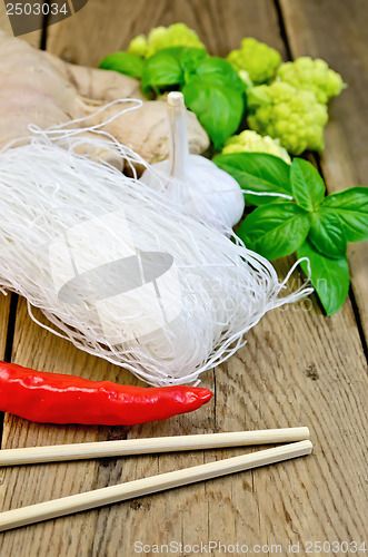 Image of Noodles rice thin with spices and broccoli on the board