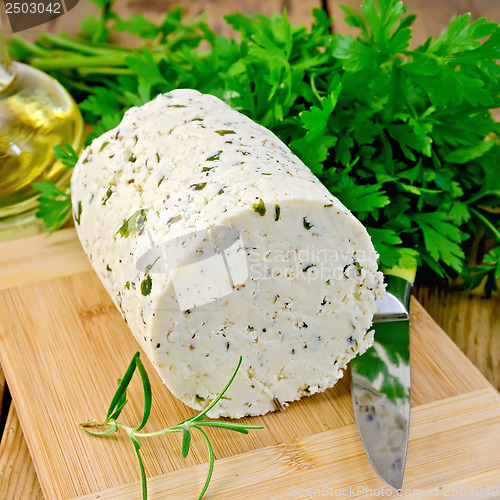 Image of Cheese homemade with herbs and knife on board