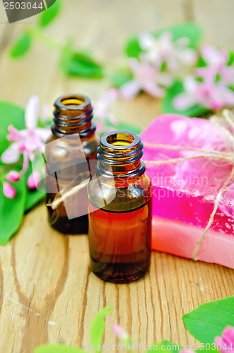 Image of Oil and pink homemade soap with flowers of honeysuckle