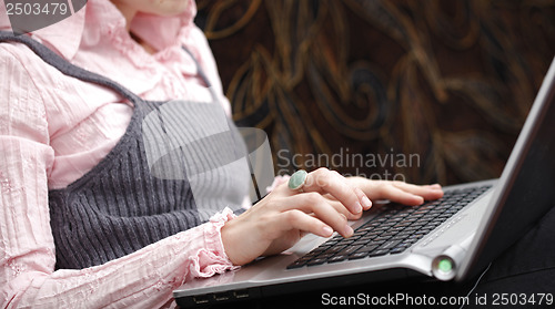 Image of Young woman working on laptop