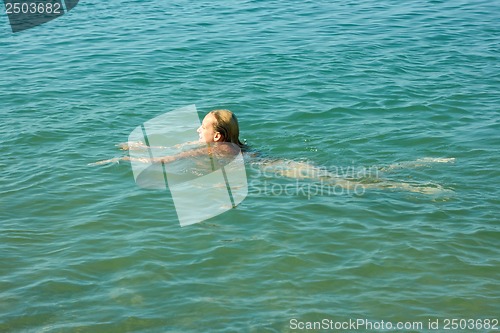 Image of Teenage girl swimming in sea water