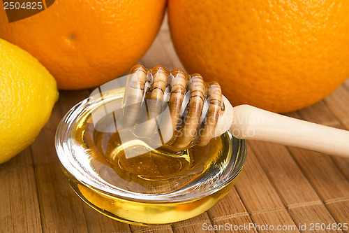 Image of fresh honey with lemon and orange fruits