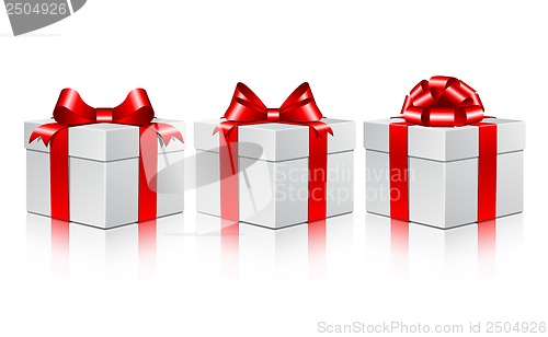 Image of Three white gift boxes with a red bows.