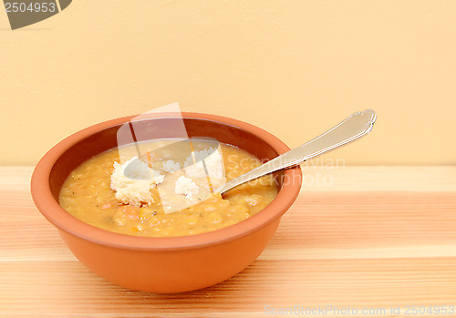 Image of Vegetable soup with torn bread pieces on top