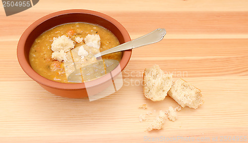 Image of Thick lentil soup with pieces of bread