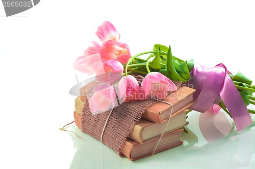 Image of Pink tulips on old books