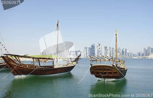 Image of Traditional wooden dhows and Doha skyline