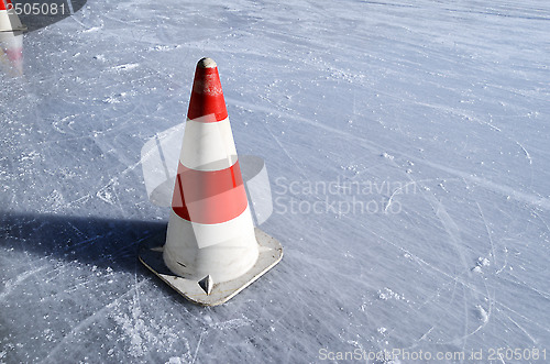 Image of red white striped cones on the rink