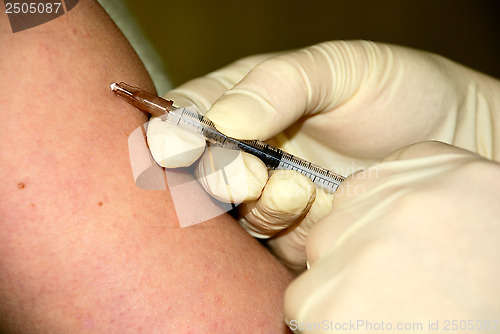 Image of nurse is giving an injection
