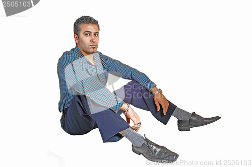 Image of Man sitting on floor.