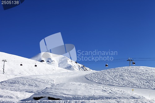 Image of Gondola lift and ski slope at nice day