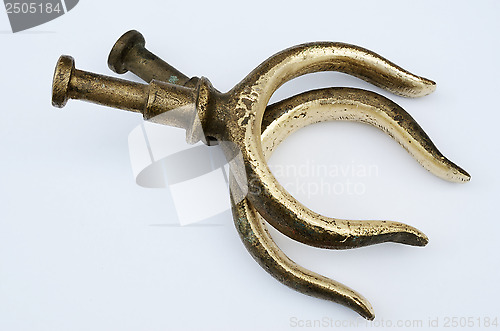 Image of two bronze oarlocks on a light background