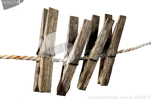 Image of four old clothes pegs