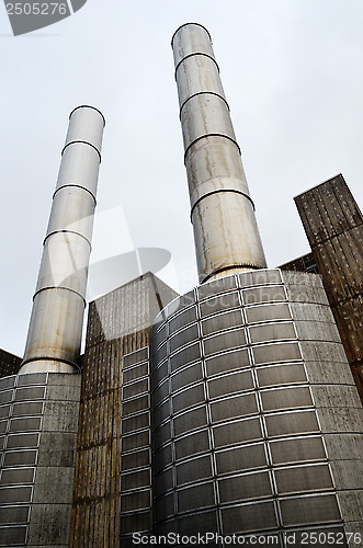 Image of industrial building and two metal chimney