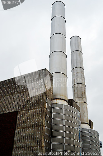 Image of two metal chimney against the gray sky