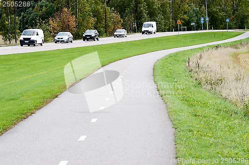 Image of empty asphalt bike path and motor road 