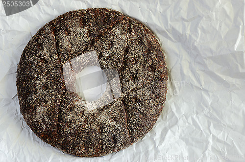 Image of finnish traditional round ray bread on a crumpled white paper