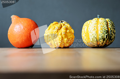 Image of three pumpkins in a row 