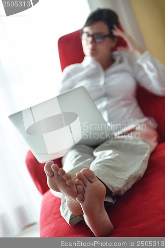 Image of woman using a laptop computer at home