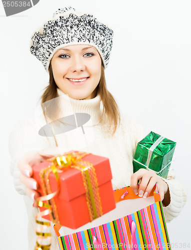 Image of Charming smiling girl holding a gift box