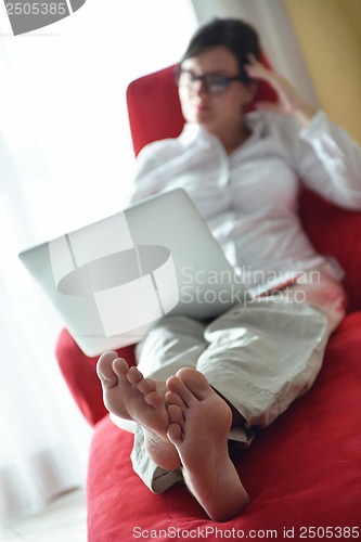 Image of woman using a laptop computer at home