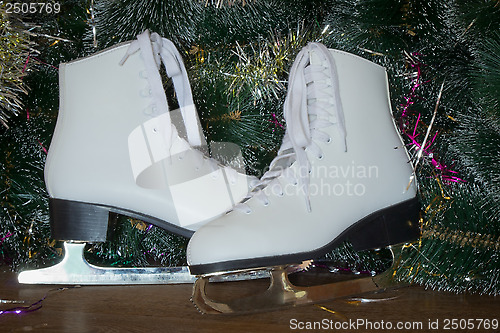 Image of New year's gift - the beautiful woman skates.