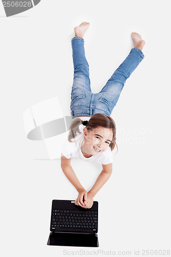 Image of Little student girl with a laptop