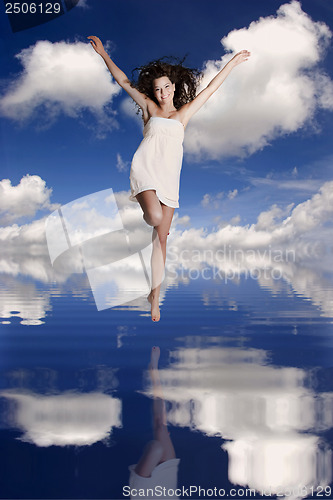 Image of Girl jumping over the water