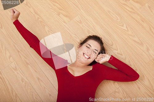 Image of Happy woman on the floor