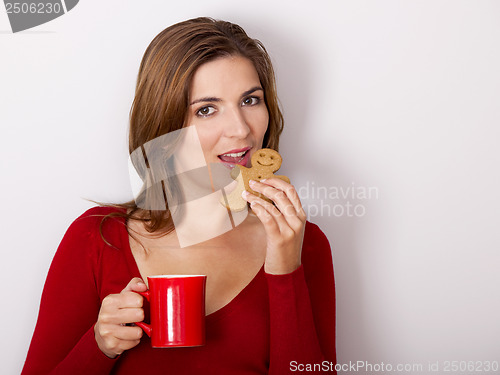 Image of Woman drinking coffee with cookies