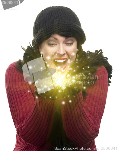 Image of Excited Woman In Winter Clothes Holds Something Sparkling In Han