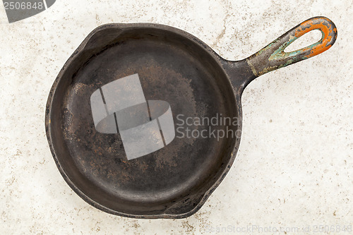 Image of iron pan on a ceramic tile