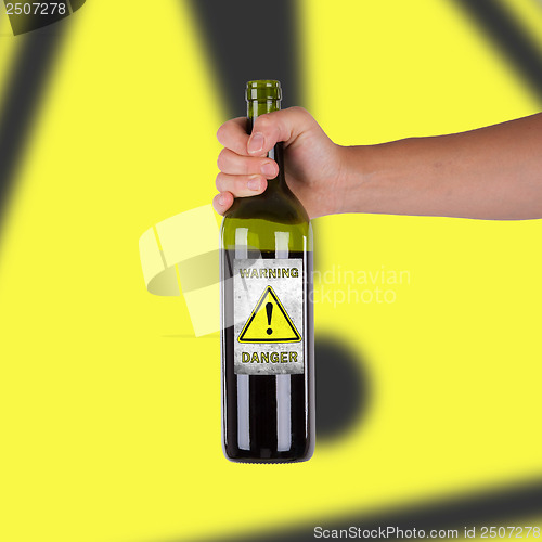 Image of Hand holding a bottle