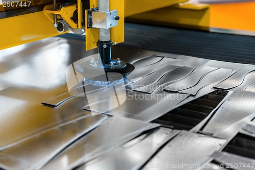 Image of Machine cutting steel in a factory