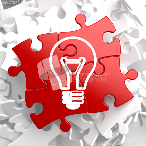 Image of Light Bulb Icon on Red Puzzle.