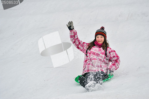 Image of girl sliding in the snow